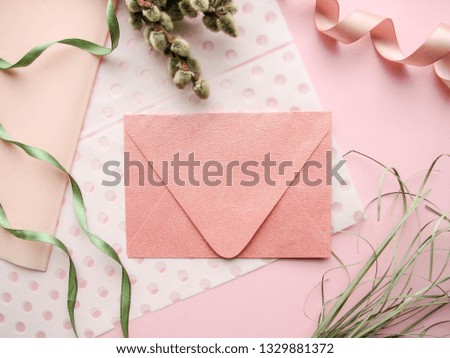 spring composition. willow twigs and envelope on a pink background. Easter card layout. congratulation