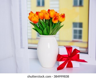 Spring Concept - Bunch Of Beautiful Orange Tulips And Gift Box On A Window Sill