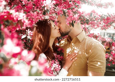 Spring couple in love. Couple in live walking in the spring Park and enjoying the beautiful spring blossom nature. Kissing couple in spring nature close-up portrait. - Powered by Shutterstock