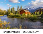 Spring Creek Alpine Village Landscape and Autumn Colors with Distant Three Sisters Mountain in Town of Canmore, Alberta Foothills of Canadian Rockies