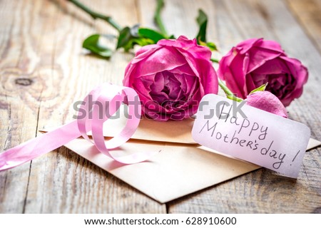 Spring design with peony flower and Mother's Day greeting card wooden background