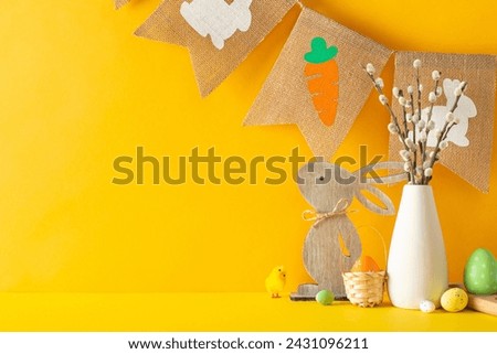 Spring Easter arrangement, presenting side view table filled with decorative items, multicolored eggs, a willow-filled vase, and old-fashioned garland, on orange wall background, space for messaging