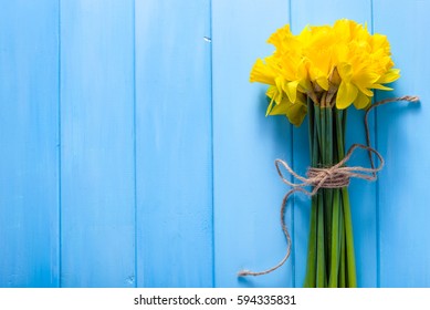 Spring easter background with daffodils bouquet on wooden table