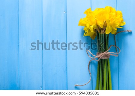 Spring easter background with daffodils bouquet on wooden table