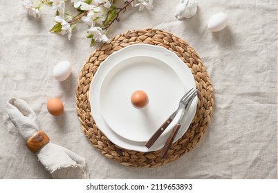 Spring Easter Festive Table Setting With Organic Brown Egg, White Bunny And Blossom Flowers Of Natural Materials. View From Above. Easter Brunch.