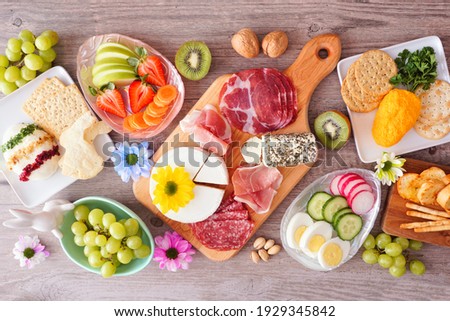 Similar – Image, Stock Photo From above of Easter-themed flatlay featuring a nest with speckled eggs, surrounded by soft feathers and pussy willow branches on a textured background