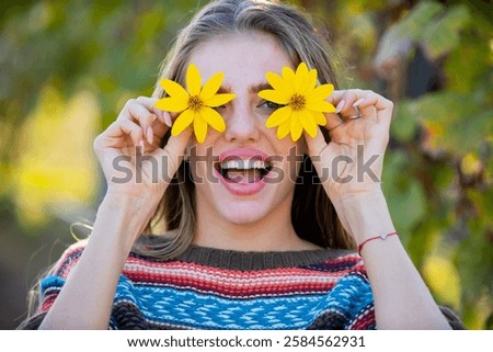 Spring face. Flower model portrait. Girl with funny expression. Fun woman in nature. Romantic flower portrait. Beautiful girl with blossom. Woman with floral smile. Funny summer face portrait.