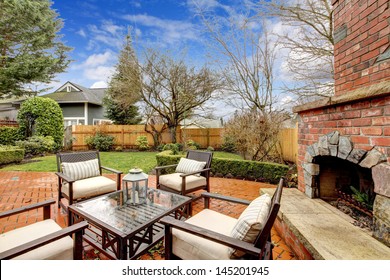 Spring Fenced Luxury  Backyard With Outdoor Fireplace And Furniture.