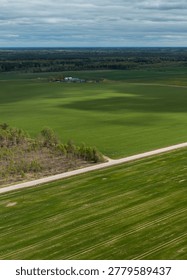 Spring Fields in Zemgale with Dramatic Clouds and Country Road