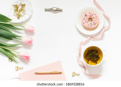 Spring Flat Lay With A Bouquet Of Pink Tulips. A Woman's Workplace. Tea Break With Donat. Copy Space