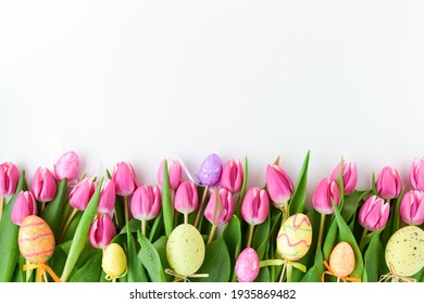 spring flat lay with tulips and easter eggs isolated on white.