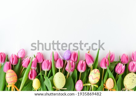 spring flat lay with tulips and easter eggs isolated on white.