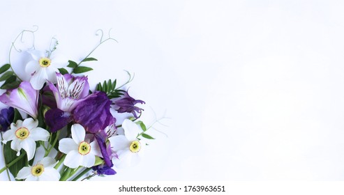 Spring Flower Arrangement - White Daffodils, Lilac Alstroemeria, Purple Irises On A White Background. Background For Greetings, Invitations, And Postcards.