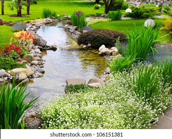 Spring Flowers In The Asian Garden With A Pond