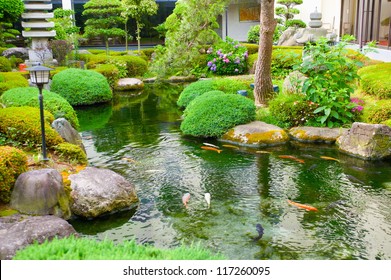 Spring Flowers In The Asian Garden With A Pond