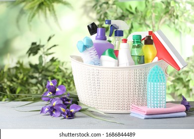 Spring flowers and cleaning supplies on light wooden table - Powered by Shutterstock