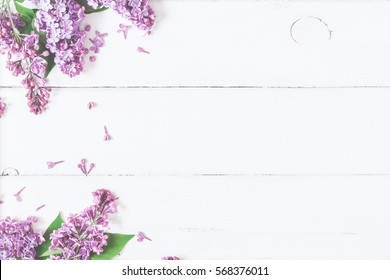 Spring flowers. Lilac flowers on white wooden background. Top view, flat lay, copy space - Shutterstock ID 568376011