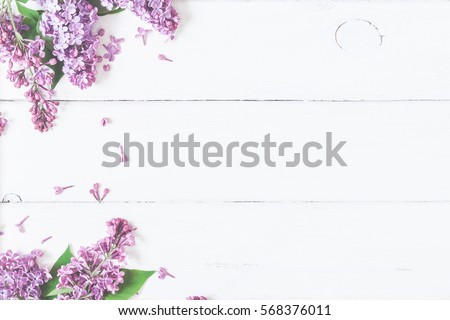 Spring flowers. Lilac flowers on white wooden background. Top view, flat lay, copy space
