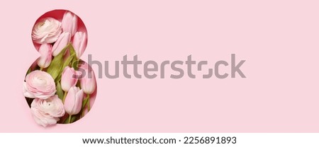 Spring flowers visible through cut pink paper in shape of figure 8. Banner for Women's Day 