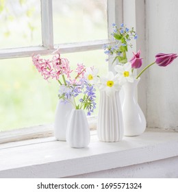Spring Flowers In White Vase On Old Windowsill