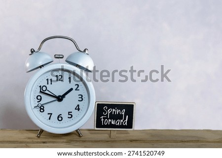 Spring Forward Daylight saving time concept with sunflowers alarm clock copy space