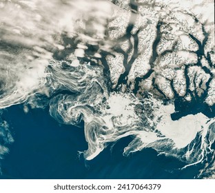 Spring Freeze in the Labrador Sea. Filaments of sea ice stretch across the waters off southern Greenland, an area that is typically icefree. Elements of this image furnished by NASA. - Powered by Shutterstock