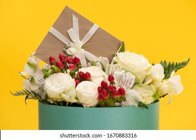 Spring Fresh Bouquet Of Flowers In Festive Gift Box With Greeting Card Isolated On Yellow
