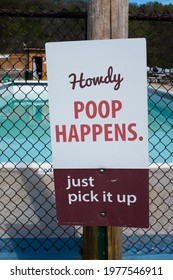 SPRING GROVE, MN, USA - 05-10-21 - A Humorous Sign At A Southeast Minnesota RV Campground Swimming Pool Area Reminds Pet Owner To Pick Up After Their Pets.