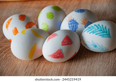Spring holiday at Sunday. Eastertide and Eastertime. Good Friday. Hunting eggs. Painted eggs. Easter eggs on wooden table. Happy Easter holiday celebration. Easter bunny hunt. Dyed Easter eggs.