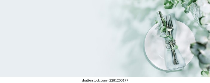 Spring holiday table settings on light blue background with eucalyptus leaves and shadows. Romantic summer holiday card with setting suitable for menu. Flat lay, banner size, copy space - Shutterstock ID 2281200177