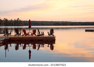 Spring Lake cottage country northern Ontario Canada Parry Sound  District. Beautiful sky floating dock reflection still calm water. Muskoka Adirondack chairs. Pristine landscape. Sunrise sunset pastel - Powered by Shutterstock