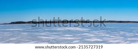 spring lake in ice against the sky panorama 2022