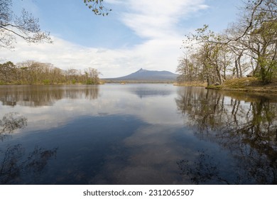 Spring lake view in Onuma National Park or Onuma Kokutei Koen and Mt. Komagatake (Komagatake volcano), Hakodate, Hokkaido, Japan - Shutterstock ID 2312065507