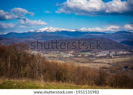 Spring landscape of the city in the valley of the Carpathian mountains