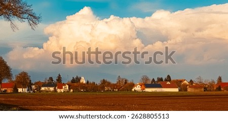 Spring landscape with huge stormclouds on a sunny day at Paitzkofen, Strasskirchen, Straubing-Bogen, Bavaria, Germany