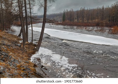 Spring Landscape In Inclement Weather With A Stream And Ice Floe In South Yakutia, Russia.