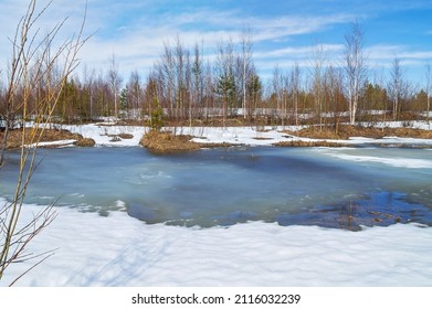  Spring landscape. Landscape with melting snow and thawed patches in the forest. Forest pond in spring.