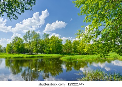 Spring landscape with Narew river and clouds on the blue sky