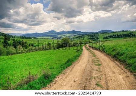 Spring landscape in Polish mountains. Mountain trail and forested hills.