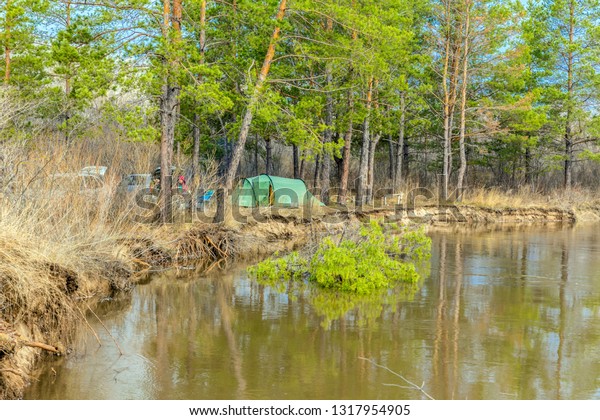 Spring landscape. Tourist camp on the banks of the\
river during the spring\
flood.