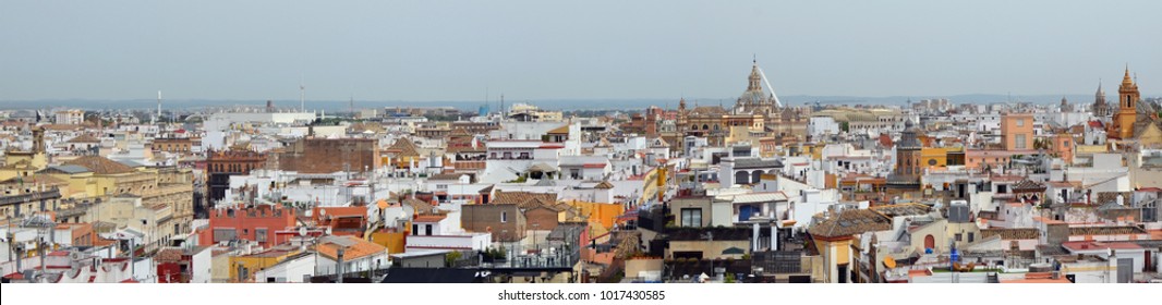 A Spring May Sky Over Spanish Seville Old Town  Roofs.  Panoramic Birds Eye View Landscape Collage From Several Outdoor Photos. All Logos And Trademarks Removed