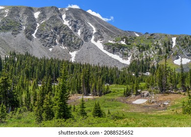Spring Mountain - A bright sunny Spring day view of a rugged high mountain peak surrounded by evergreen forest, as seen from Pawnee Pass Trail. Indian Peaks Wilderness, Colorado, USA. - Shutterstock ID 2088525652