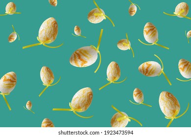 Spring pattern with flying yellow eggs on turquoise background. Zero gravity easter concept.