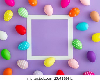 Spring pattern made of colorful Easter eggs on purple background with copy space. Minimal Easter concept. Creative festive holiday layout. Easter aesthetic. Flat lay, top of view.