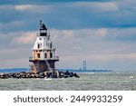 Spring photo of Southwest Ledge Light, Lighthouse, in New Haven, CT, on a cloudy day.