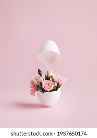 Spring Pink Flowers Popping Out Of Cracked Eggshell Against Pastel Pink Background. Easter Minimal Conceptual Layout. Creative Happy Easter, Spring Or Summer, Food Greeting Card.