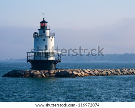 Spring Point Ledge Lighthouse with Portland Head Lighthouse in background on foggy day