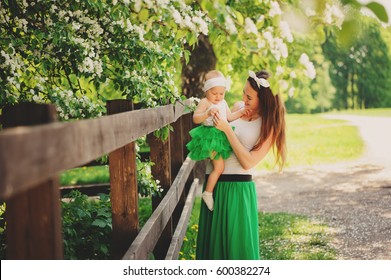 Spring Portrait Of Mother And Baby Daughter Playing Outdoor In Matching Outfit - Long Skirts And Shirts. Happy Family Enjoying Vacation