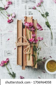 Spring Reading Concept With Books On A White Background With Purple Flowers And Lemon Tea. Feminine Flat Lay With Japanese Newspaper.