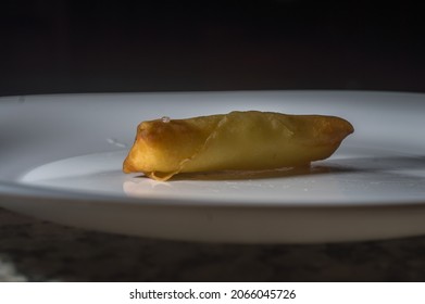 Spring Rolls On A White Brato With Hands Opening A Cheese Roll